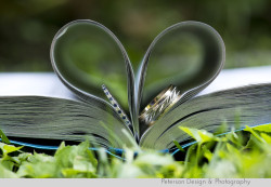 Weddings rings tucked in book pages like a heart